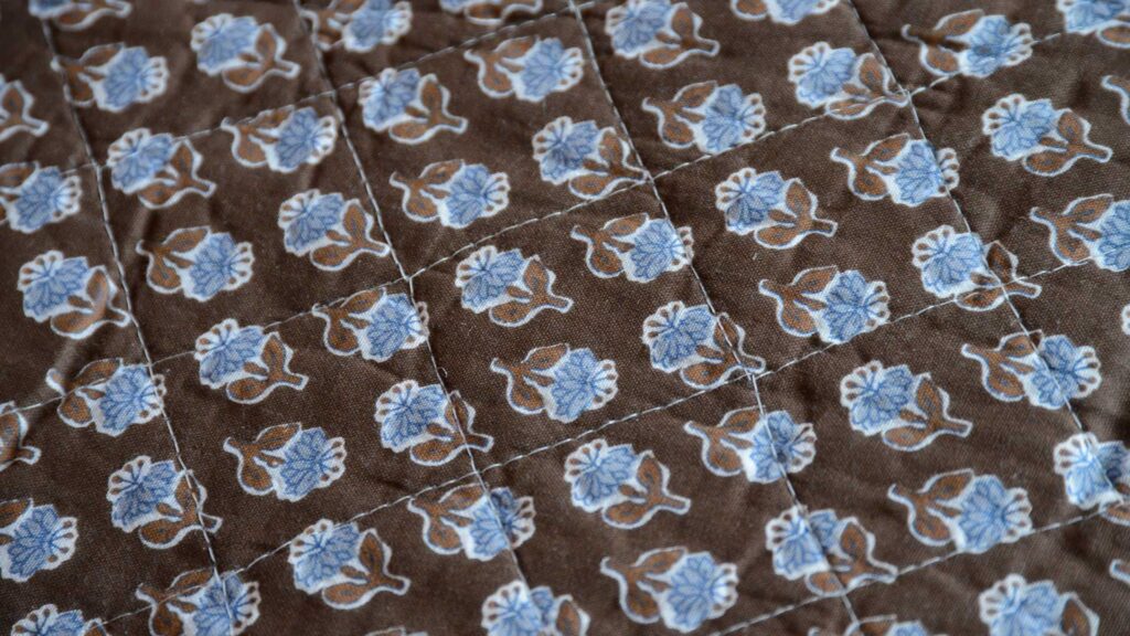 Brown Quilted Throw with Blue Flowers Closeup Pattern Detail