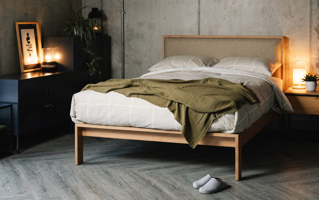 Scandinavian look bedroom featuring our Shetland bed in cherry wood, with headboard upholstered in Parquet Hessian