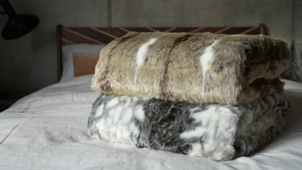 softest faux fur throws in grey or beige colours and white, shown together