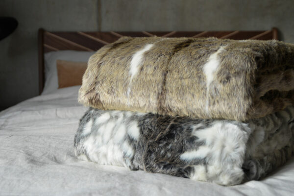 softest faux fur throws in grey or beige colours and white, shown together