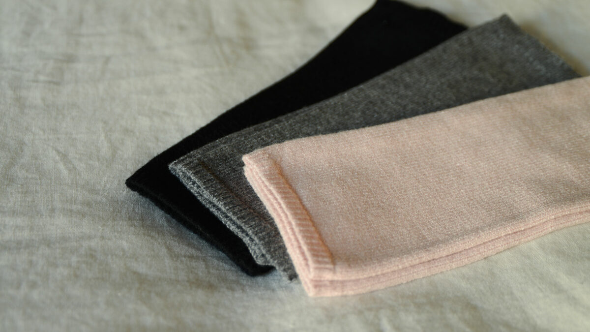 cosy knitted fingerless gloves in black, grey, and blush pink