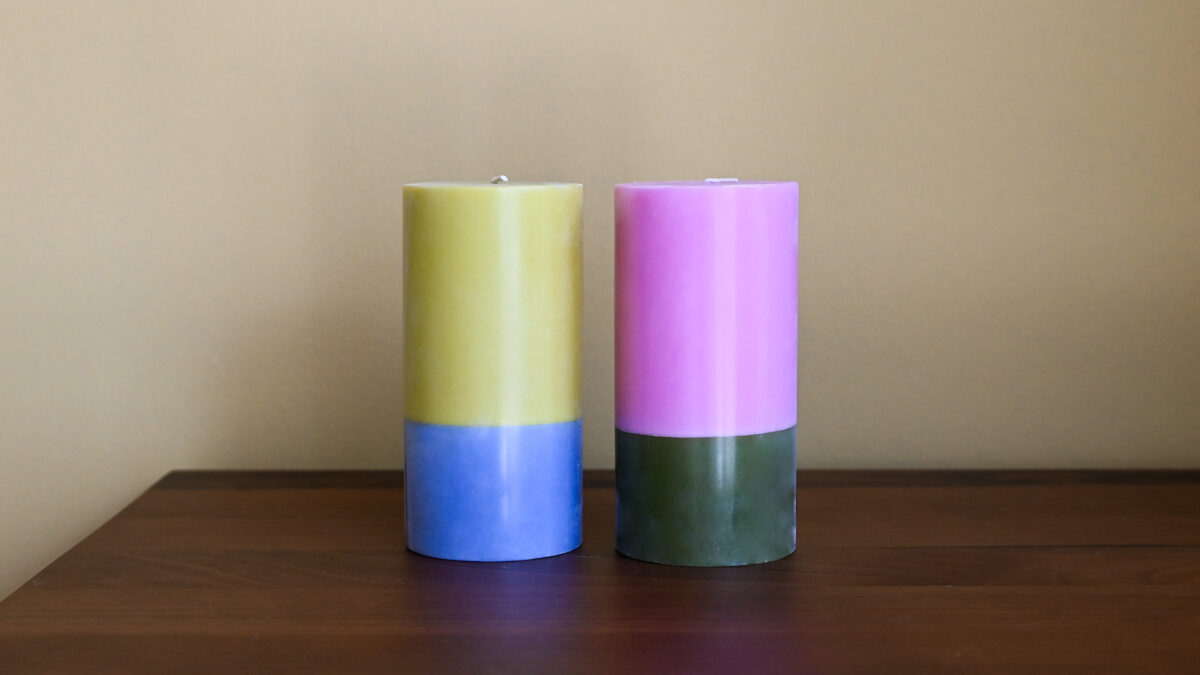 2 colour block candles, one blue and lemon, one green and pink.