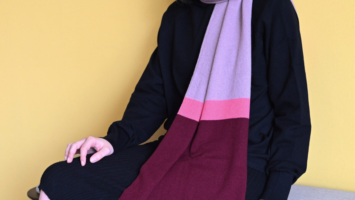 close up of purple and pink colour block scarf.