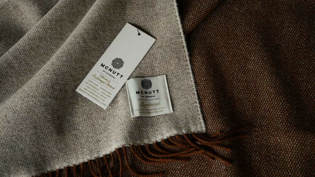 large brown and beige reversible lambswool throw shown in close up