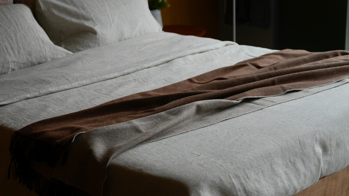 Dark Brown Reversible Throw Wide Shot on Bed