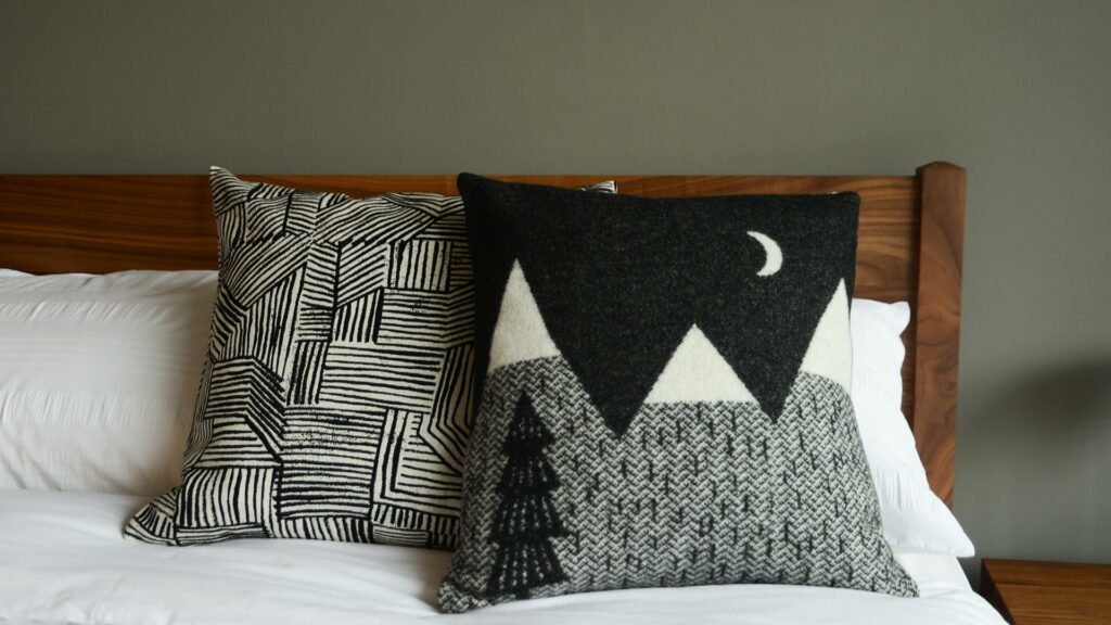 Donna Wilson knitted mountain scene cushion in black and white