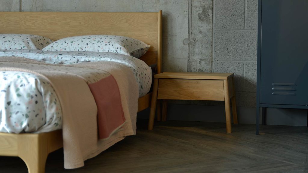 Air Bedside Table in oak with 1 drawer shown with our low Mid-century style Carnaby Bed.