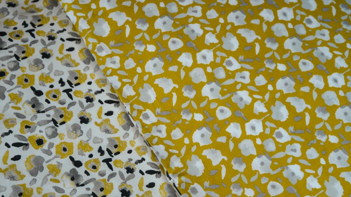 Modern floral patterned reversible duvet cover set in yellow ochre and grey showing both sides