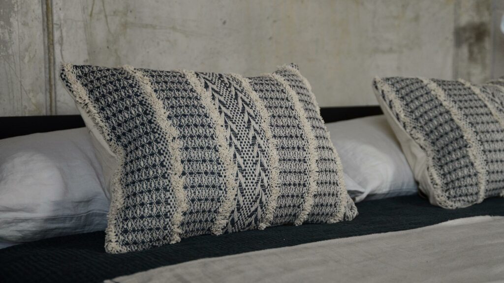 textured Boho cushions with a woven and tufted geometric pattern in black and ivory