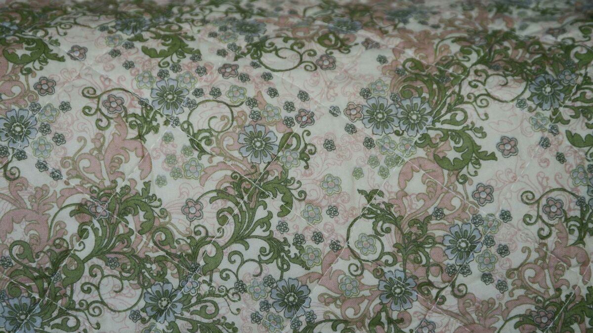 Green and Pink Patterned Quilt