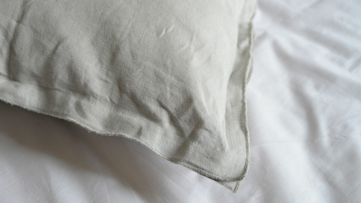 linen ruffle edge cushion in pale grey a detail view