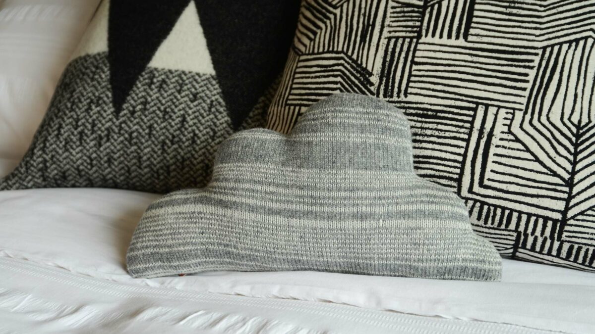 Donna Wilson small knitted cloud shaped cushion in grey and white