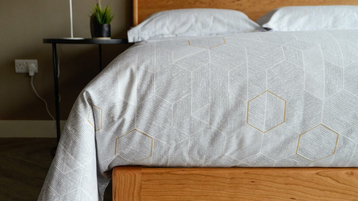 honeycomb print duvet cover set shown on a solid wood cherry camden bed