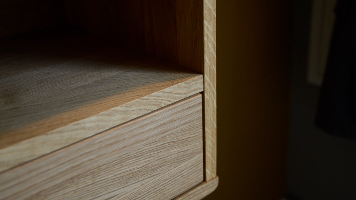 a close up look at our wall mounted oak bedside table with drawer and book shelf