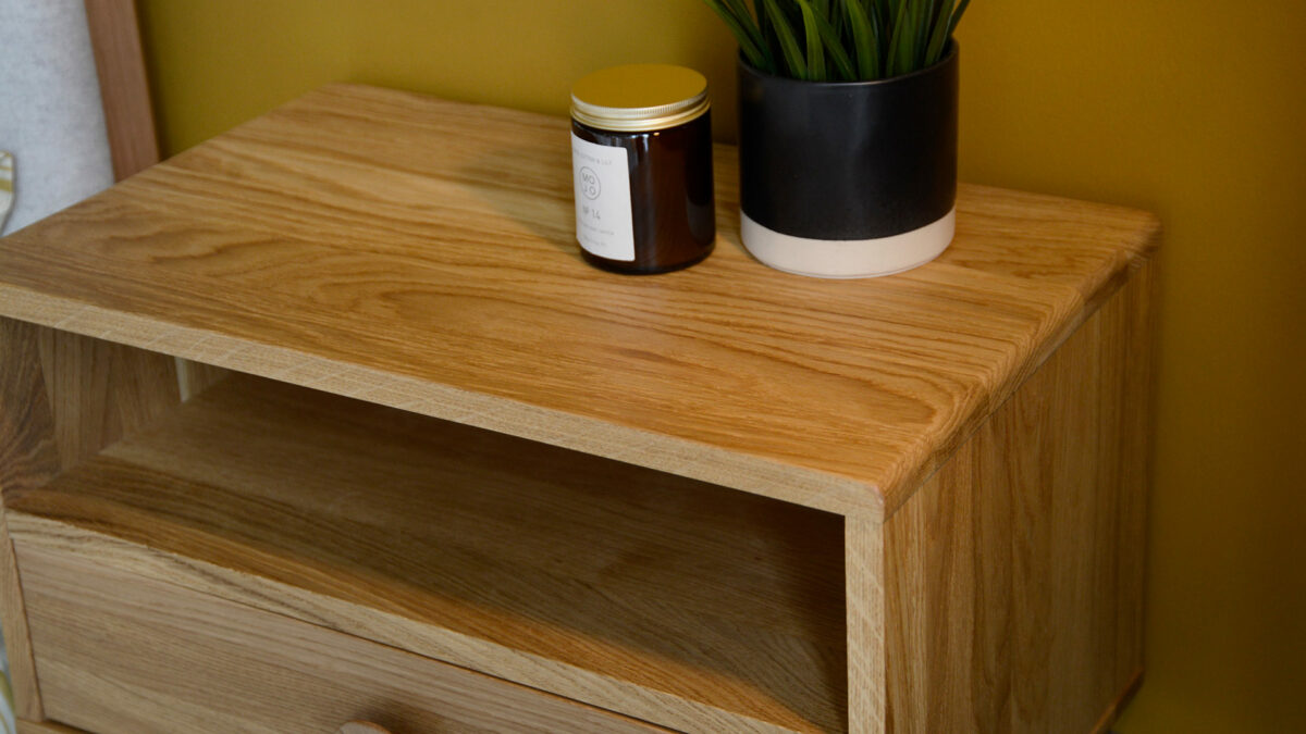 wall mounted oak bedside table with drawer and book shelf shown from above