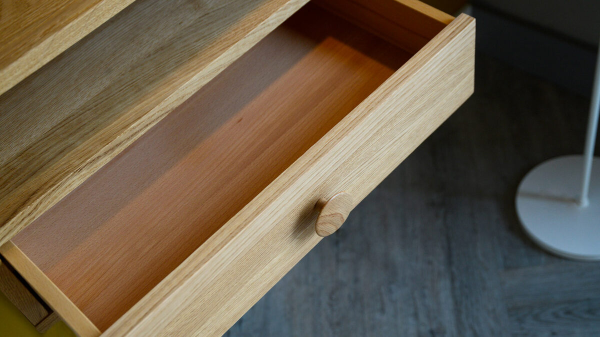 wall mounted oak bedside table with opened drawer