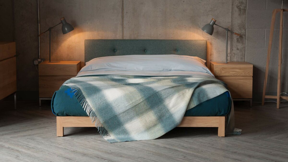 Iona a low solid wooden framed bed with an upholstered headboard. To order in a full range of bed sizes.