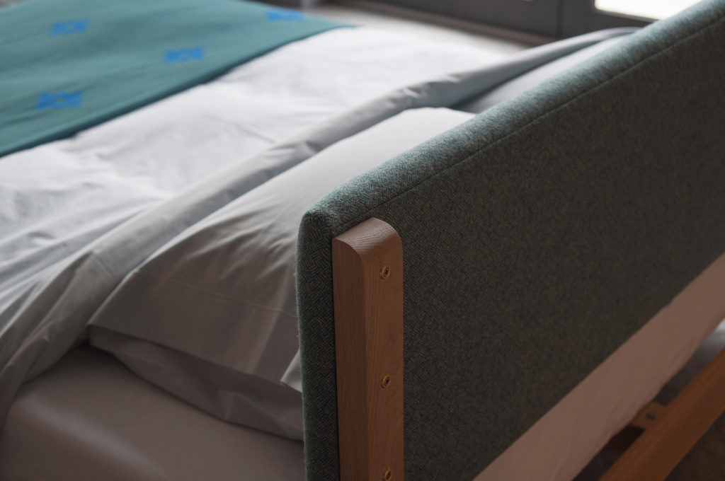 A detail view of the back of the low Iona bed padded-headboard