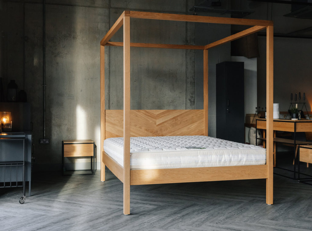 A view of the Kelham contemporary wooden 4 Poster bed shown without bedding