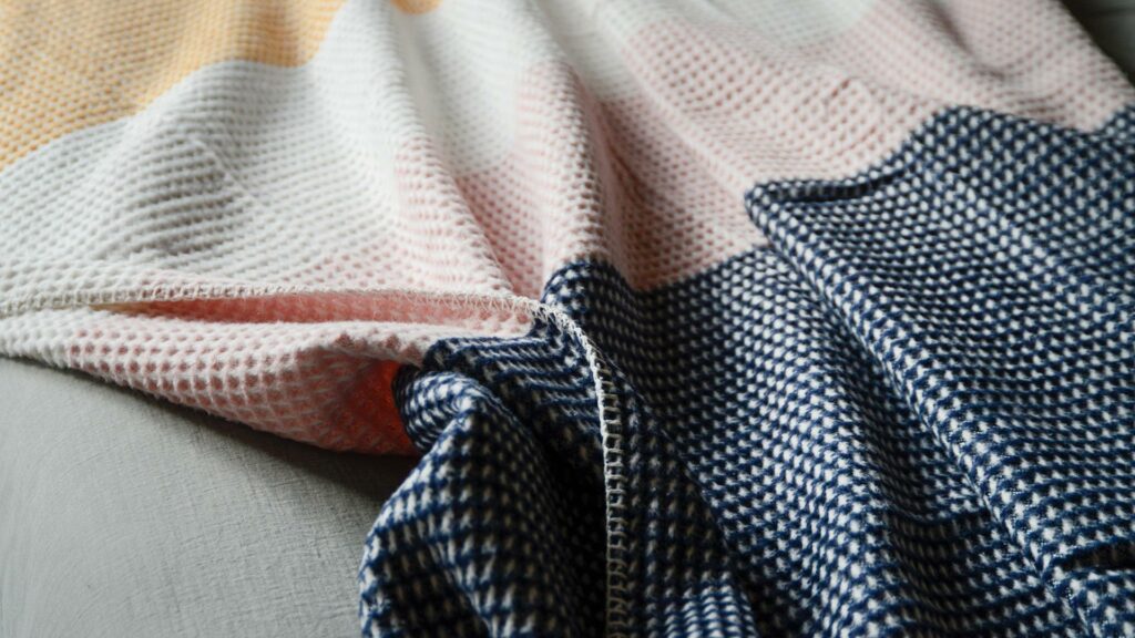 Knitted Colour Block Throws Navy Pink Closeup