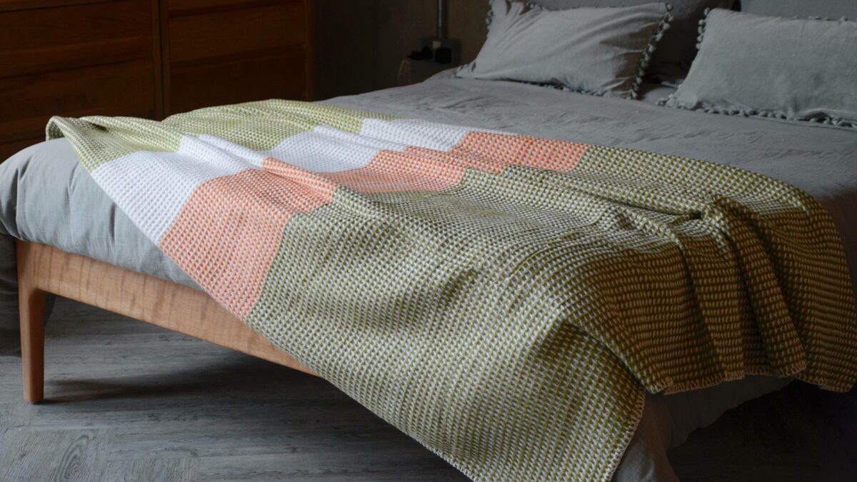 woven colour block knitted throw in green, white and orange