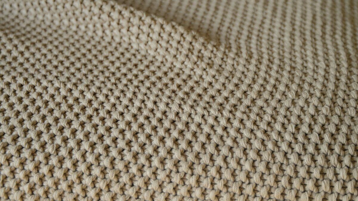 moss stitch knitted cotton throw in taupe