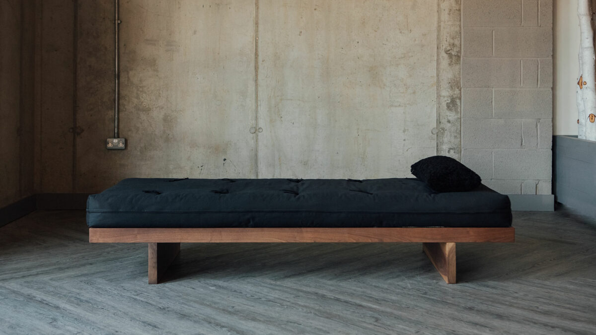 The Kyoto day-bed - its solid wood frame comes in a range of wood options. This is walnut.