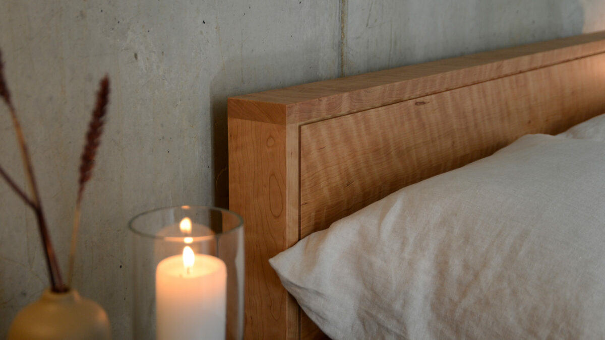 Leith bed headboard in solid cherry wood with a rippled grain