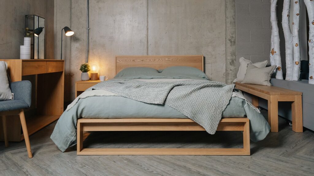 Scandinavian style bedroom - pale sage coloured linen bedding on our solid oak Leith bed