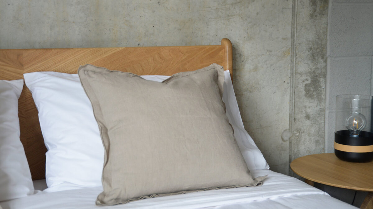 Linen ruffle edge cushion in taupe