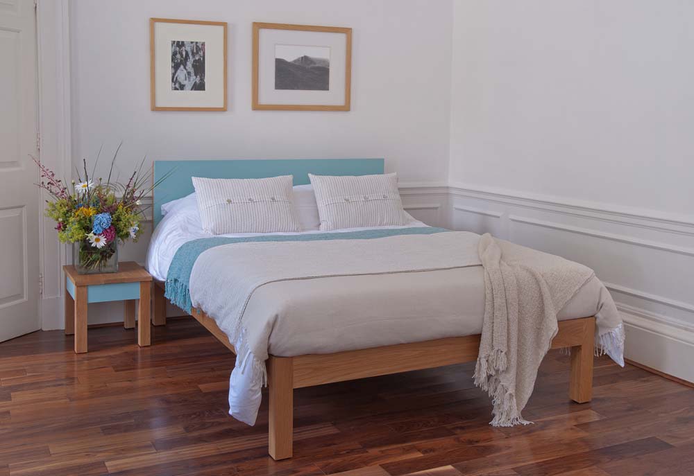 Summer bedding on the Tao solid wooden bed with painted headboard