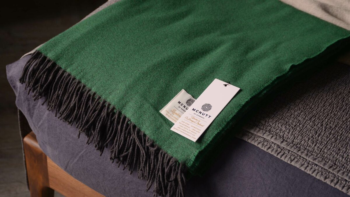 emerald green merino lambswool throw with dark fringing