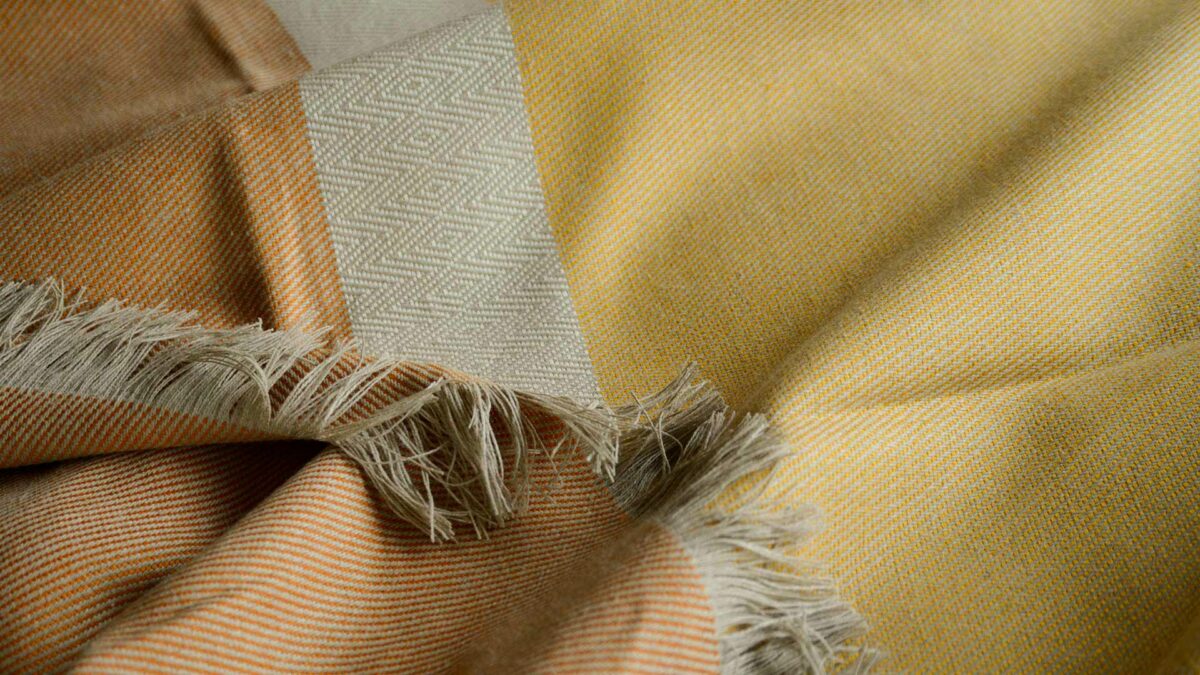 woven 100% Irish linen colour block blanket in orange, yellow and sand colours