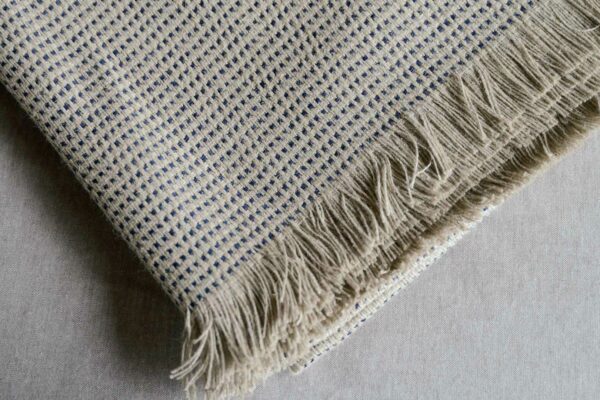 textured woven linen blanket in sand and inky blue