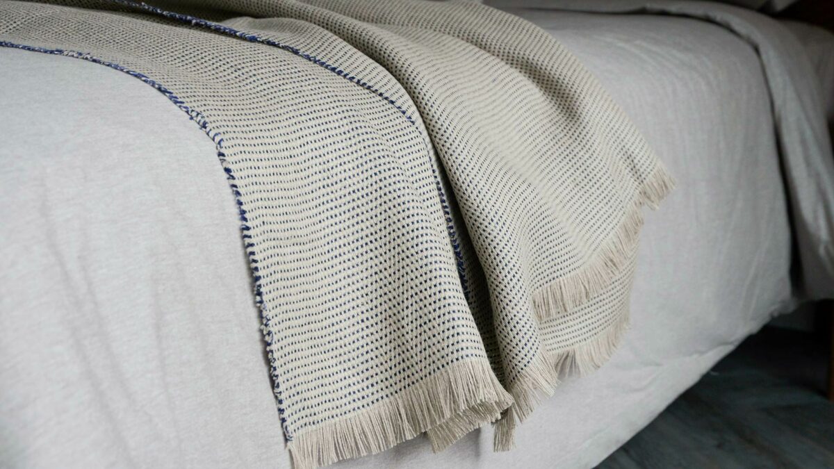 textured woven linen blanket in sand and inky blue