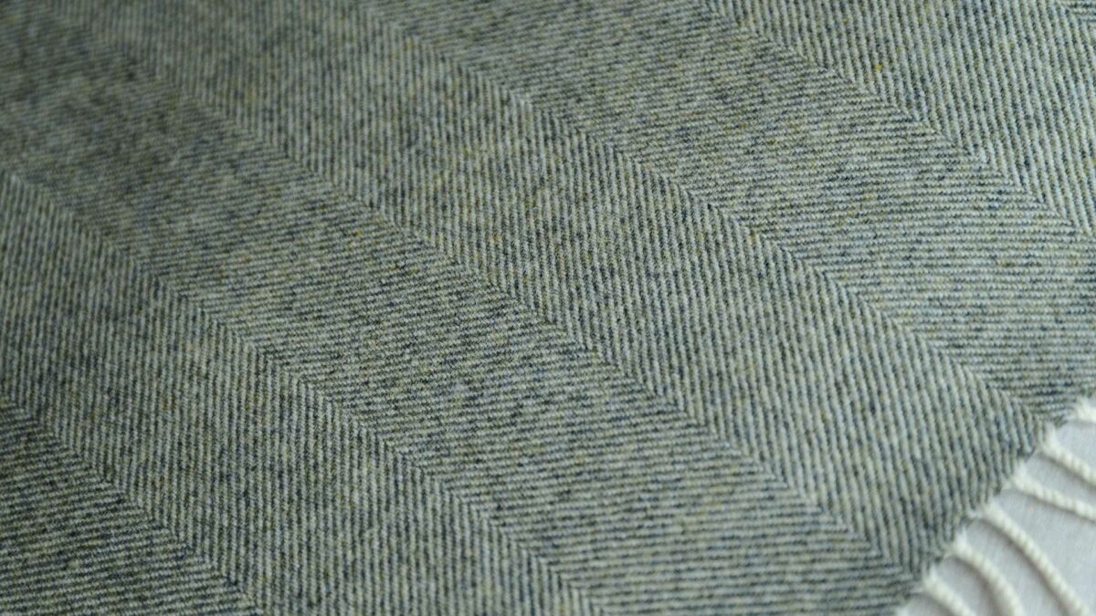 Moss green Herringbone weave lambswool throw shown close up