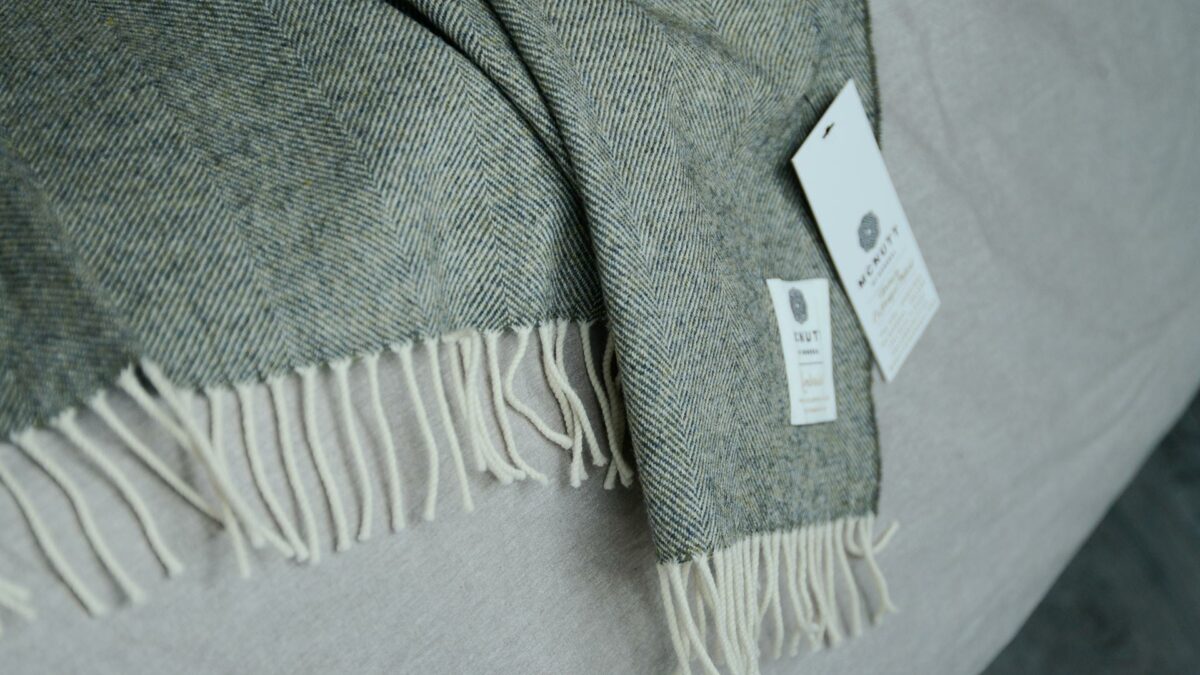 Moss green Herringbone weave lambswool throw a close up of the fringing