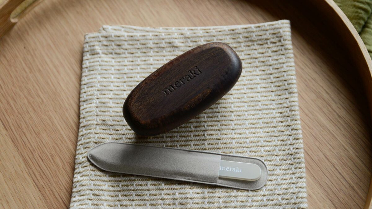 Meraki Dark Ash Nail Brush on oak tray top down view
