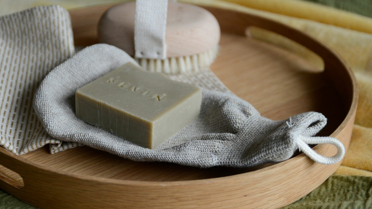 Meraki Exfoliating Glove on oak tray with Sevin soap