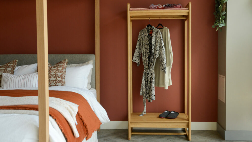 Mid Century Oak Open Wardrobe with robes in Highalnd roomset