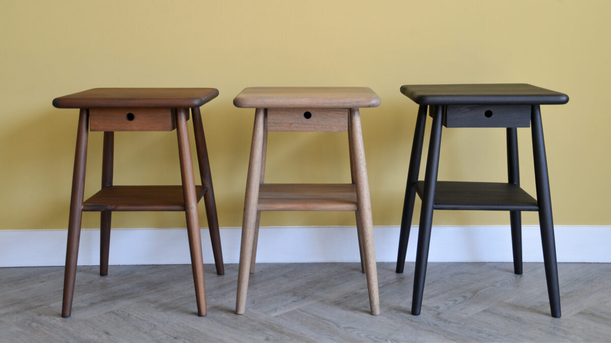 Row of three Mid-Century side tables, showing (from left to right) the finishes walnut, grey oil and earth.