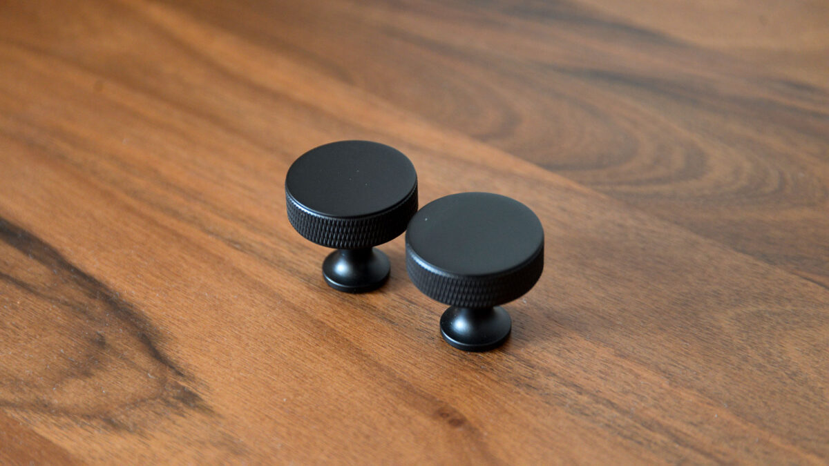 2 round black hooks on table top.
