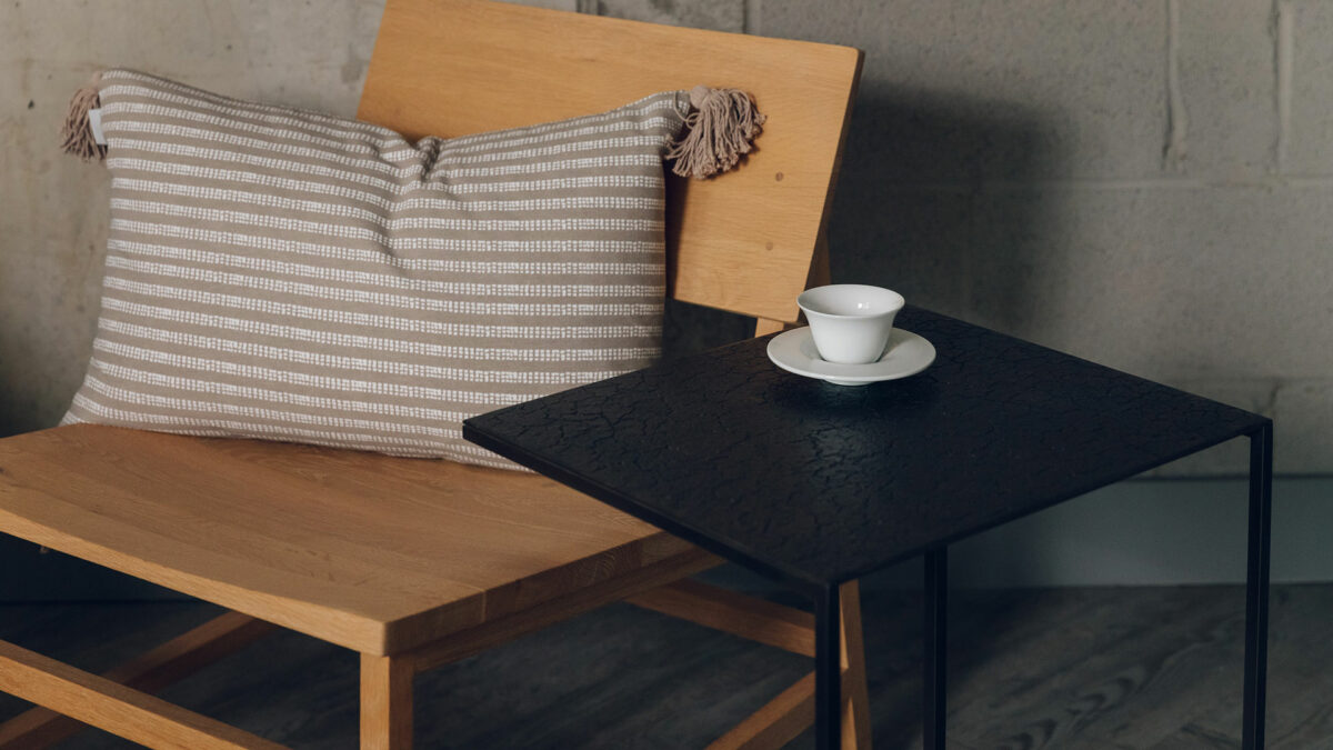N2 chair lava side table with striped taupe cushion