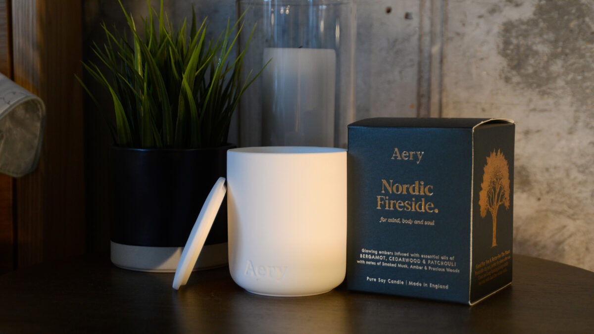 Nordic Fireside scented candle in a ceramic pot with lid shown with box