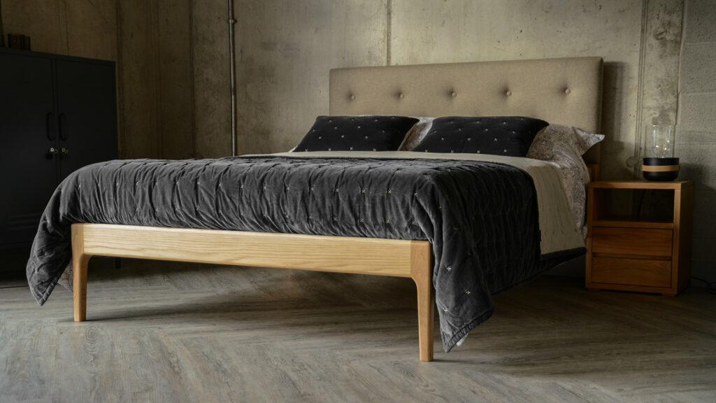 The handcrafted oak Bloomsbury bed with buttoned and padded headboard.