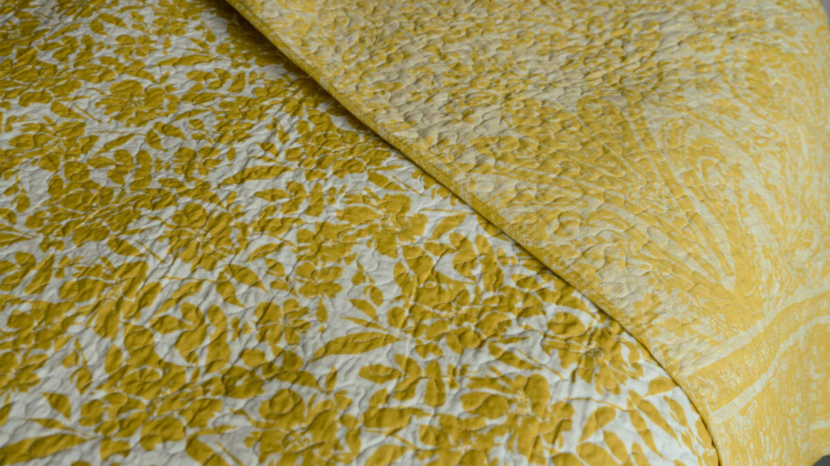 reversible printed floral pattern quilted bedspread in ivory and yellow ochre