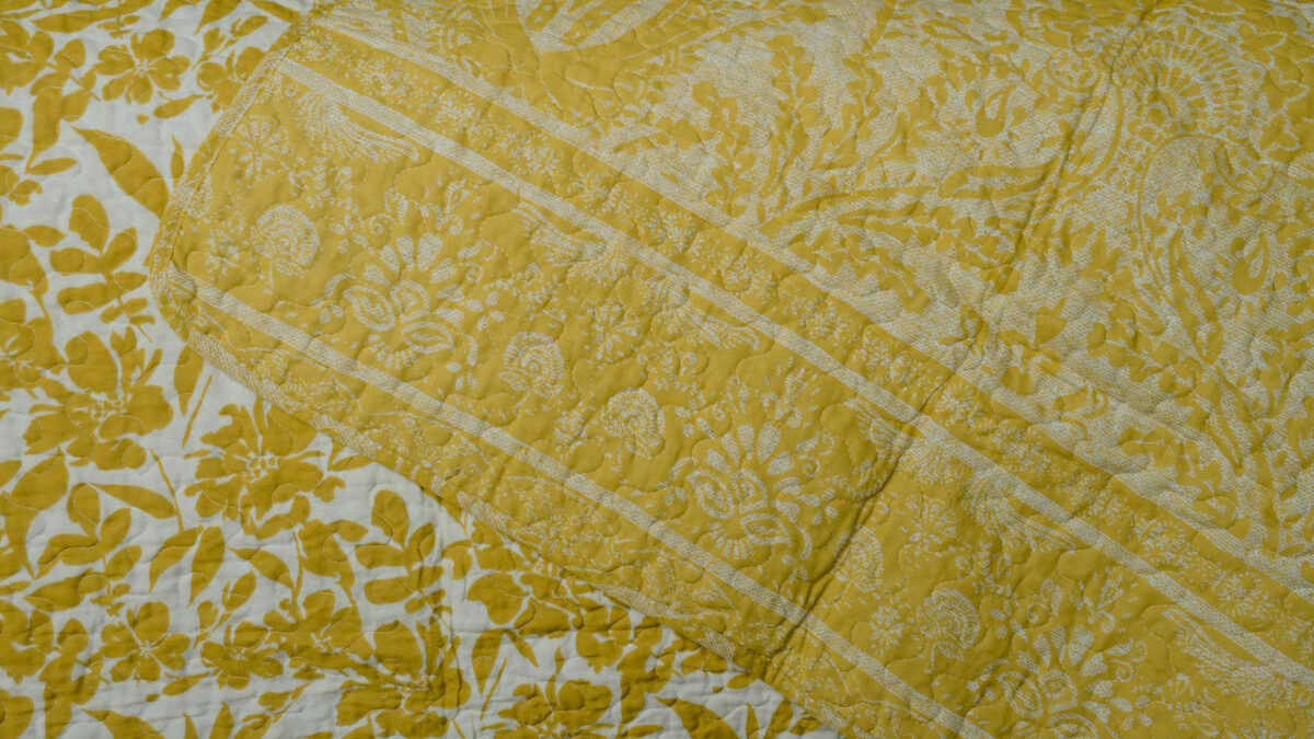 reversible printed floral pattern quilted bedspread in ivory and yellow ochre