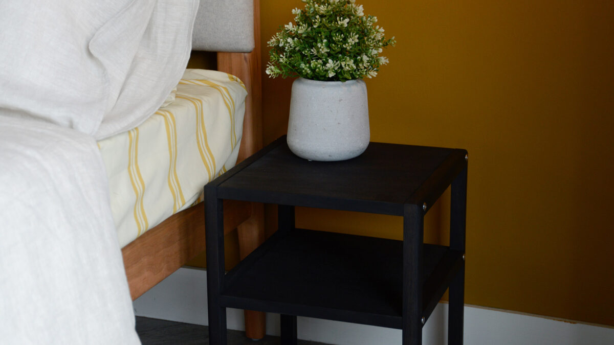 open shelf wooden bedside table with a dark earth stain