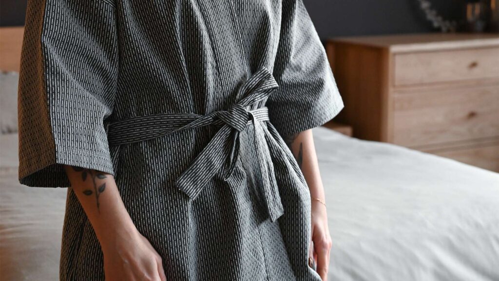 Grey spa robe with short sleeves and matching tie.