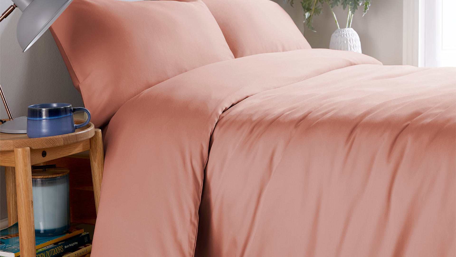 natural blush pink coloured organic cotton bedding 300 thread count shown on a bed